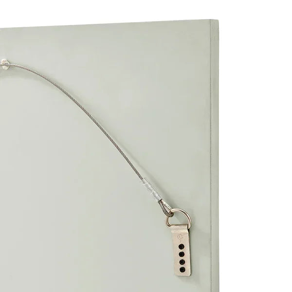 Closeup of picture frame back with hanging wire and metal hook attachment