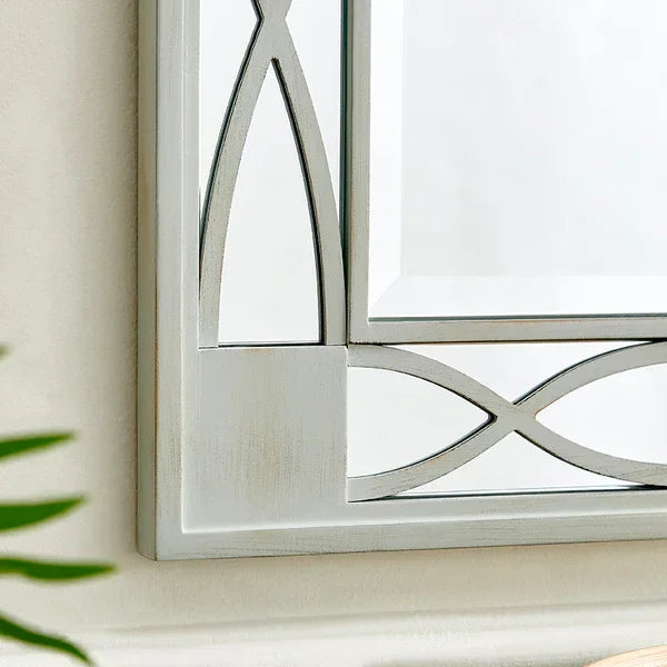 Decorative wall mirror with silver geometric frame close-up