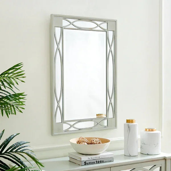 Rectangular wall mirror with geometric silver frame above modern console table