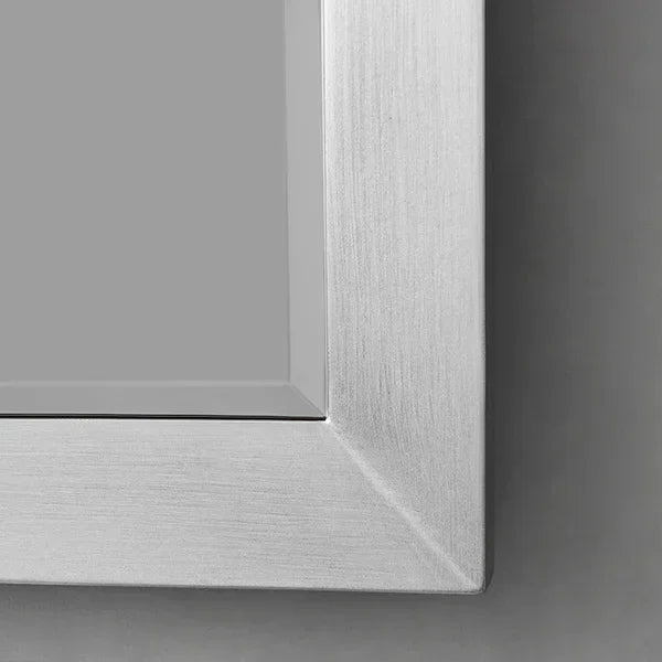 Brushed silver mirror frame close-up with smooth metallic finish and sharp corner detail