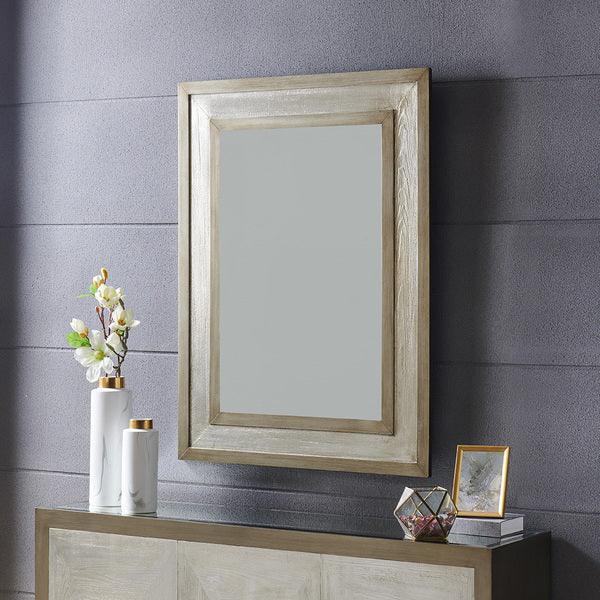 Rectangular silver wall mirror above console table with white vases and decorative accents