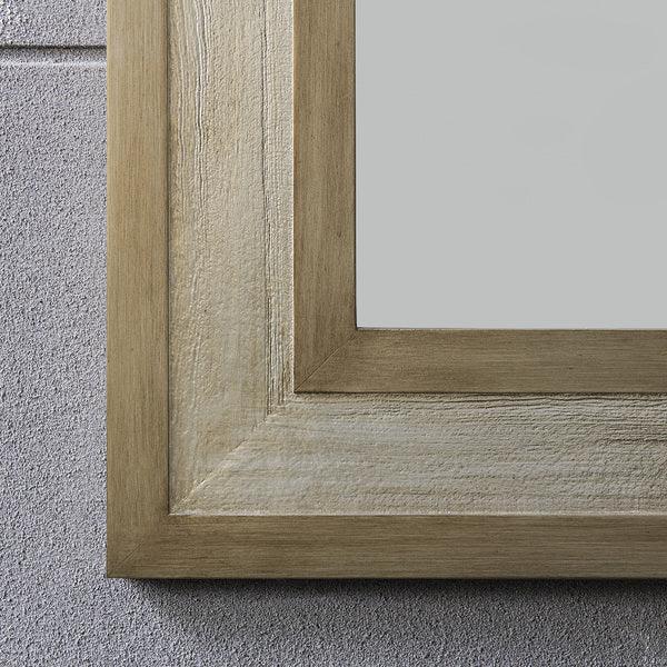 Natural wood mirror frame with textured surface on light grey wall