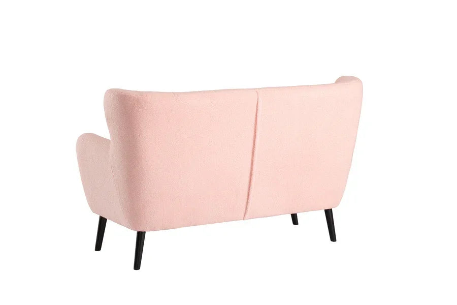 Blush pink fabric sofa with slim black legs rear view