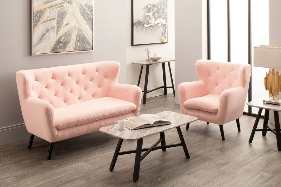 Pink fabric sofa and armchair set with tufted backs and marble coffee table in modern living room