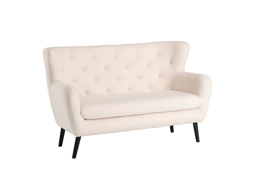 Cream fabric sofa with tufted backrest and black angled legs