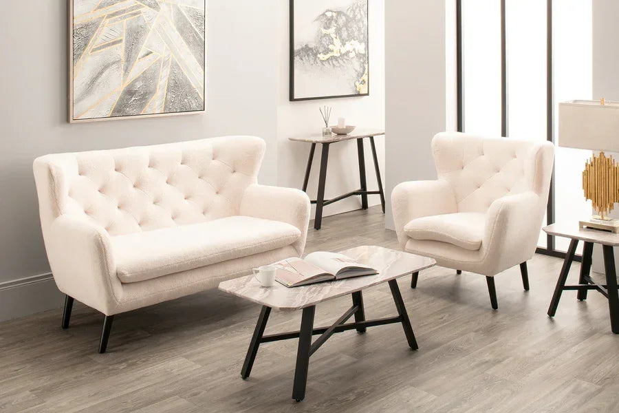 Cream fabric sofa and armchair set with button tufting in modern living room, marble coffee table