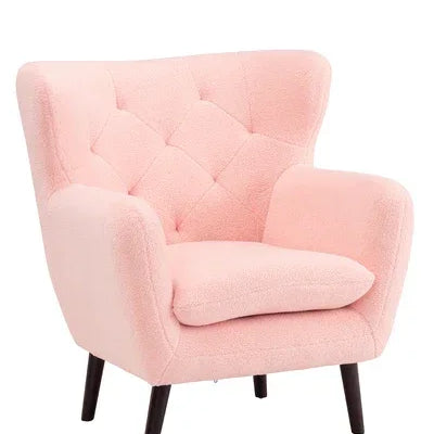 Pink accent armchair with tufted back and angled wooden legs