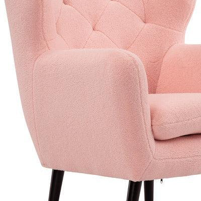 Pink armchair with tufted backrest and wooden legs, close-up of seat and arm detail