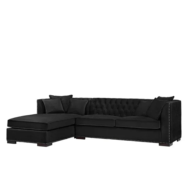 Black corner sofa with chaise, button-tufted back, studded trim, and scatter cushions