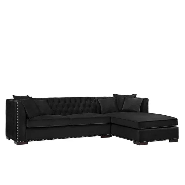 Black velvet corner sofa with chaise, button-tufted back, stud detailing and scatter cushions