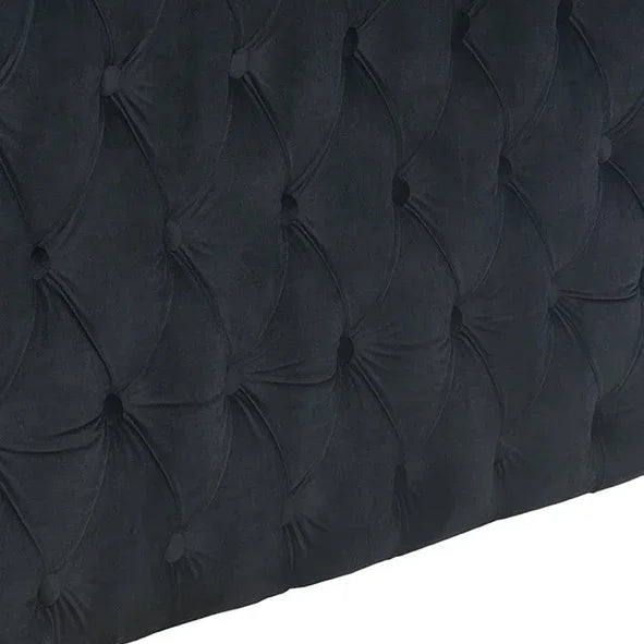 Dark velvet upholstered headboard with deep button tufting detail