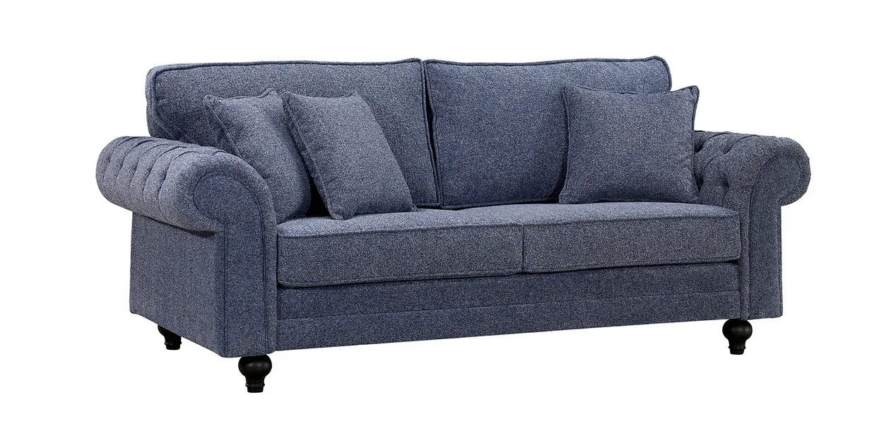 Blue fabric sofa with rolled arms, tufted detailing, and four matching cushions on wooden legs