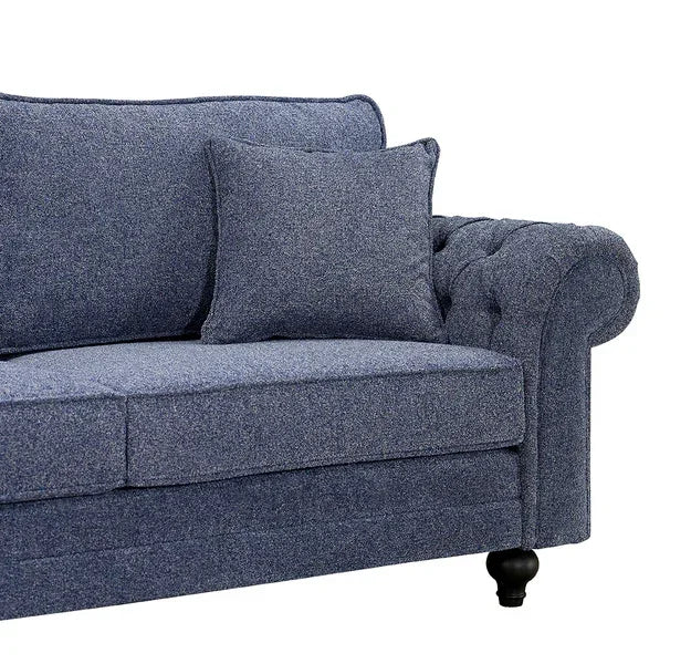 Blue fabric sofa with cushion and tufted armrest, wooden legs visible