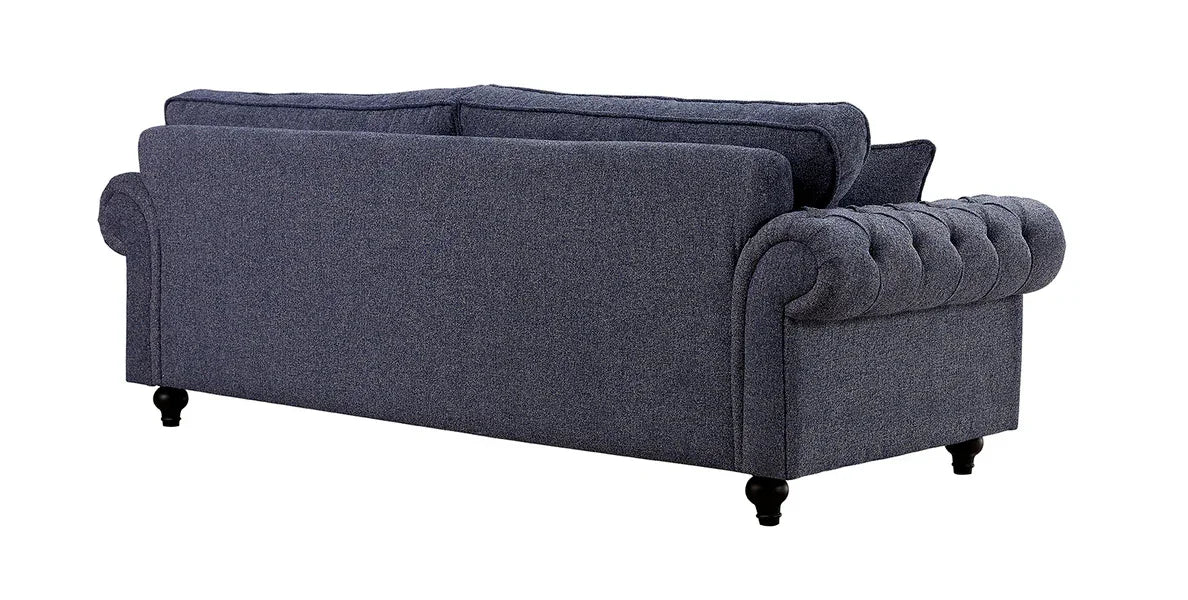 Grey fabric sofa with rolled arms and button tufting, rear view showing wooden feet