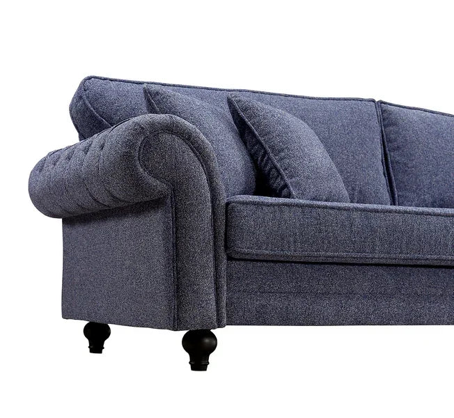 Dark grey fabric sofa with rolled armrest, scatter back cushions, and turned wooden legs