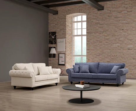 Beige and blue fabric sofas with rolled arms in modern living room with round coffee table