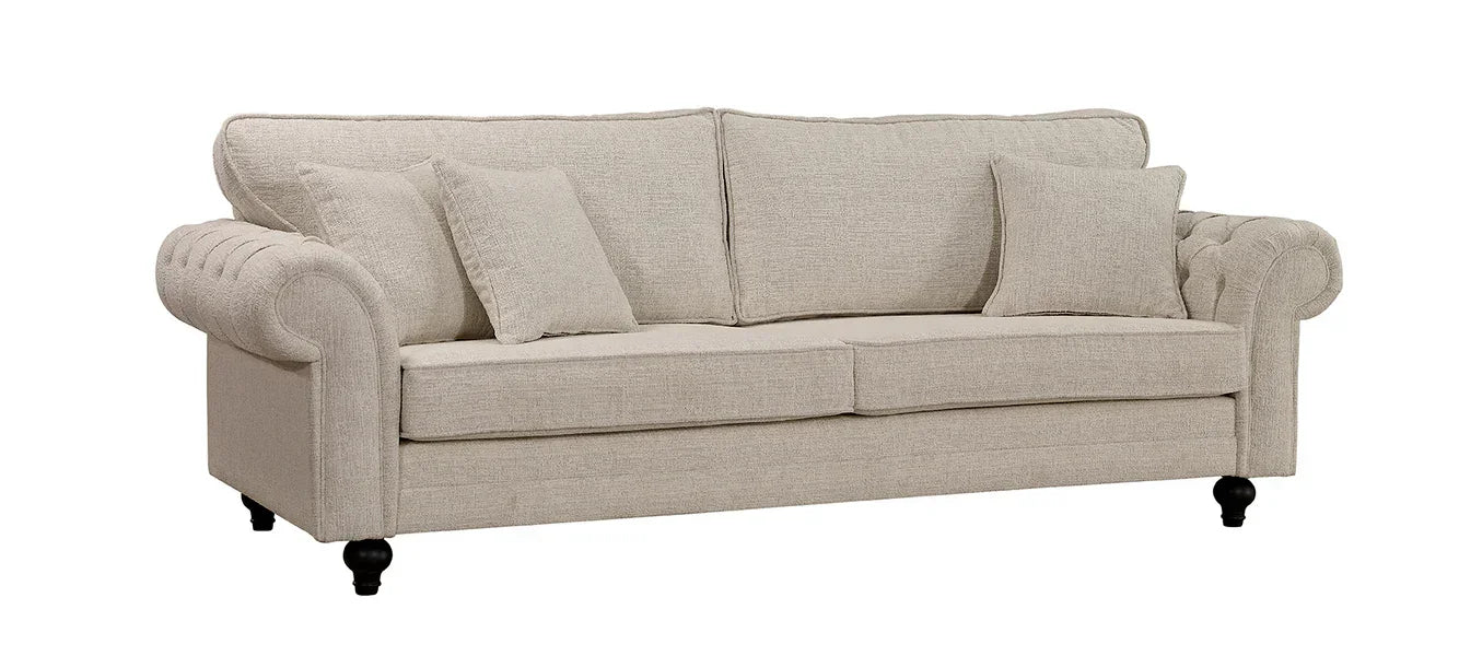 Beige fabric sofa with rolled arms, three seat cushions, and matching scatter cushions