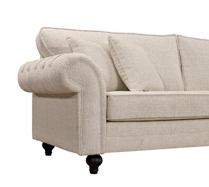 Beige fabric sofa with rolled armrest, button detail, and dark wooden legs
