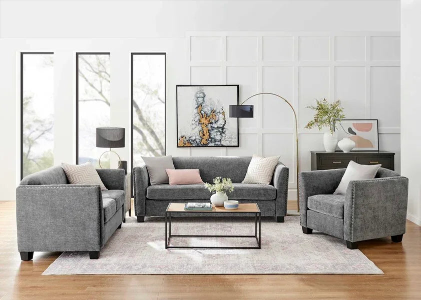 Grey fabric sofa set with cushions and modern coffee table in bright living room