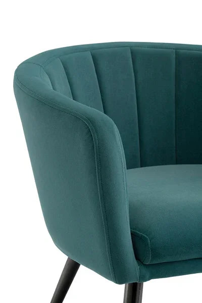 Teal velvet accent chair with curved backrest and black legs, close view