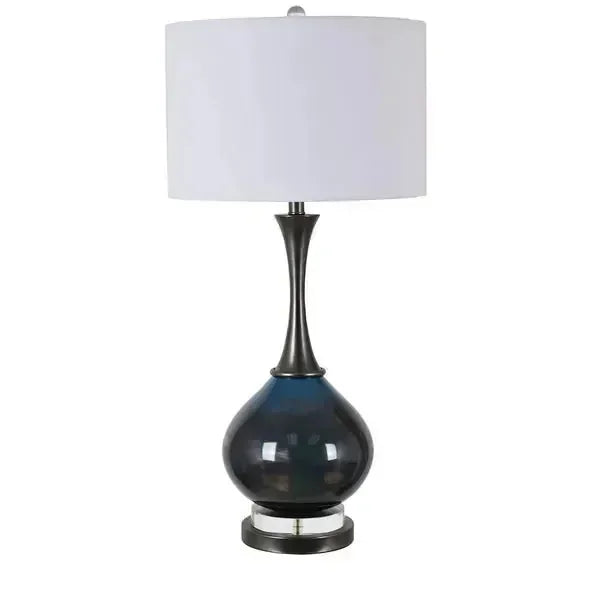Blue glass table lamp with metallic base and white drum shade