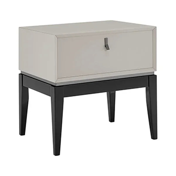 Modern bedside table with single beige drawer and black wood legs, front angle view