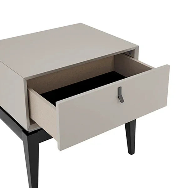 Modern bedside table with beige drawer open and black legs