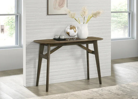 Dark wood console table in hallway with globe, vase, and decor accents