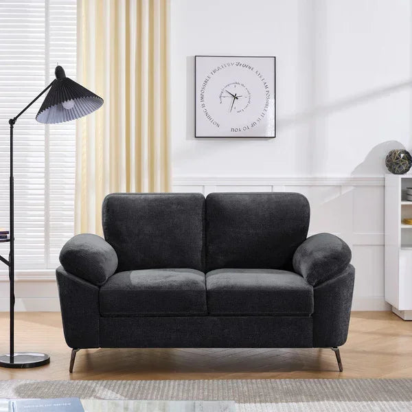 Dark grey fabric sofa with curved arms in modern living room setting