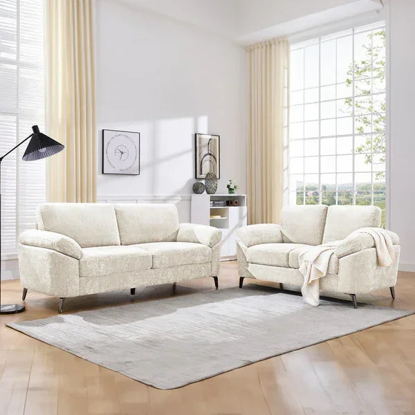 Cream fabric sofa set with modern armchairs on light rug in bright living room