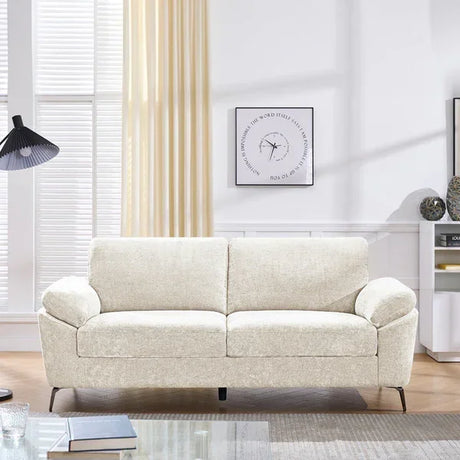 Cream fabric sofa with cushioned arms in modern living room setting
