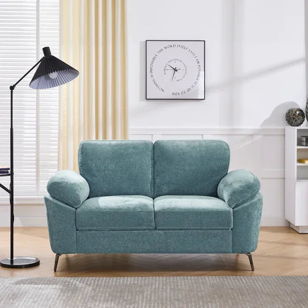 Teal fabric two-seater sofa with metal legs in a modern living room setting