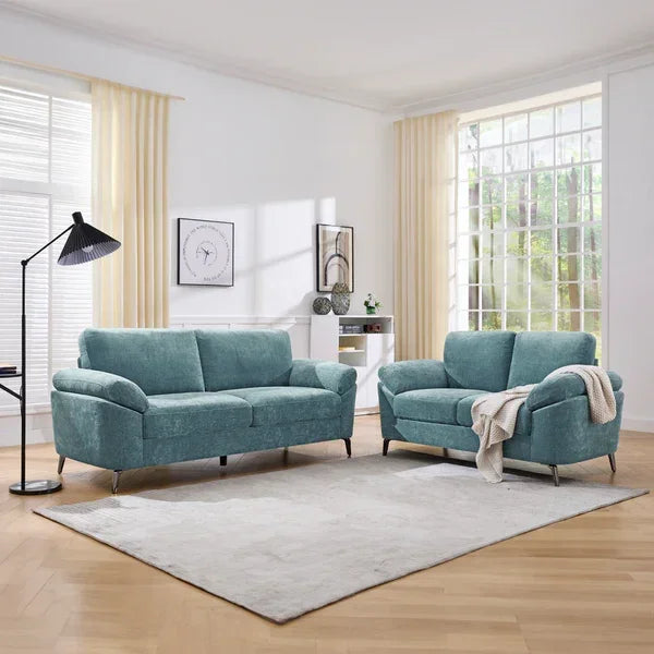 Teal fabric sofas set with metal legs in bright modern living room on light rug
