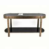 Gold metal and black glass console table with lower shelf and book on top