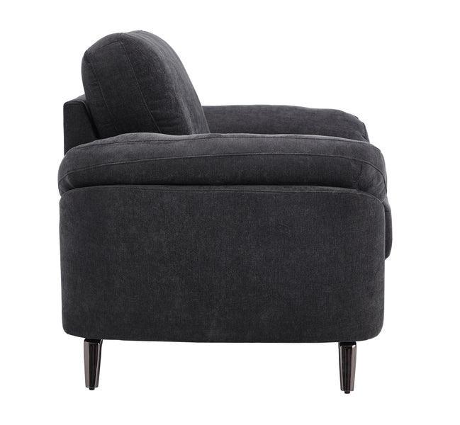 Side view of dark grey fabric armchair with slim black legs and plush back cushion