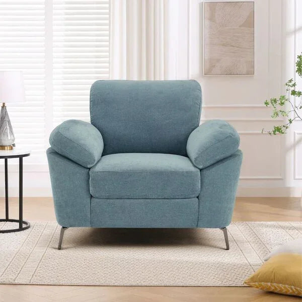 Blue fabric armchair with cushioned arms and metal legs in modern living room