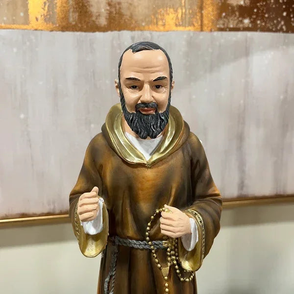 Bearded monk figurine in brown robe holding prayer beads, displayed against a neutral background