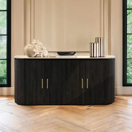 Black sideboard with gold handles and marble top in modern dining room setting
