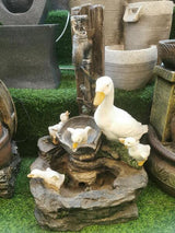 Garden duck water feature with white duck and ducklings on artificial grass display