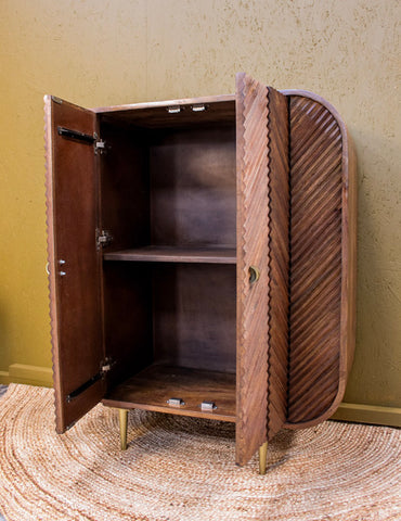 Wooden cabinet with chevron pattern doors open showing interior shelf