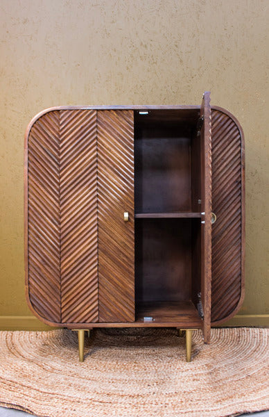Wooden cabinet with chevron pattern doors, one door open showing two shelves