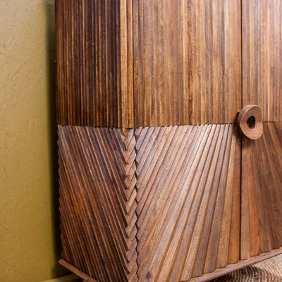 Wooden cabinet with intricate diagonal chip design and round handle on tapered legs
