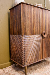 Wooden cabinet with intricate diagonal chip design and round handle on tapered legs