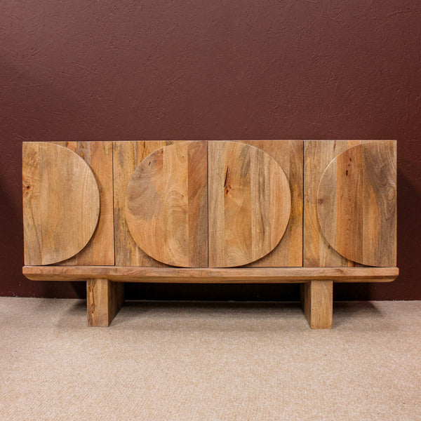Wooden sideboard with four doors featuring oval patterns on a beige carpet