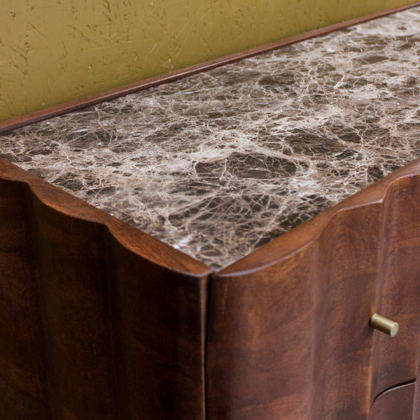 Dark brown wooden cabinet with marble top and brass drawer handle