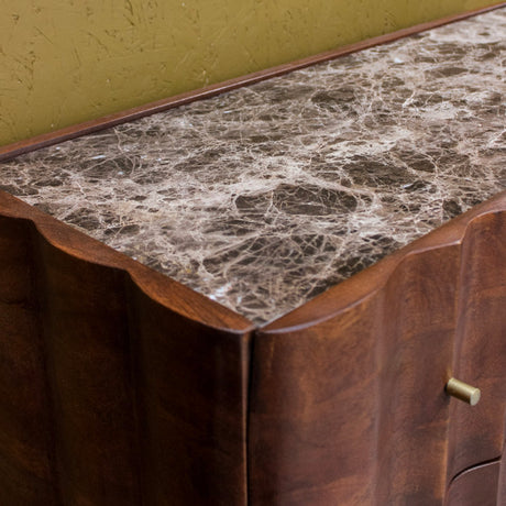 Dark brown wooden cabinet with marble top and brass drawer handle