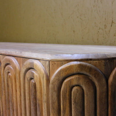 Wooden sideboard with capsule-shaped carved panels and smooth top