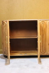 Open wooden sideboard showing inner shelves and curved smooth doors with handles