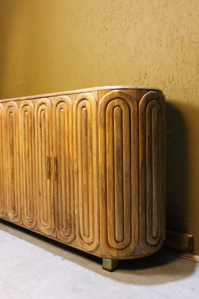 Wooden sideboard with rounded edges and capsule carved door design