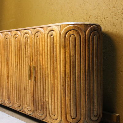 Wooden sideboard with rounded edges and capsule carved door design